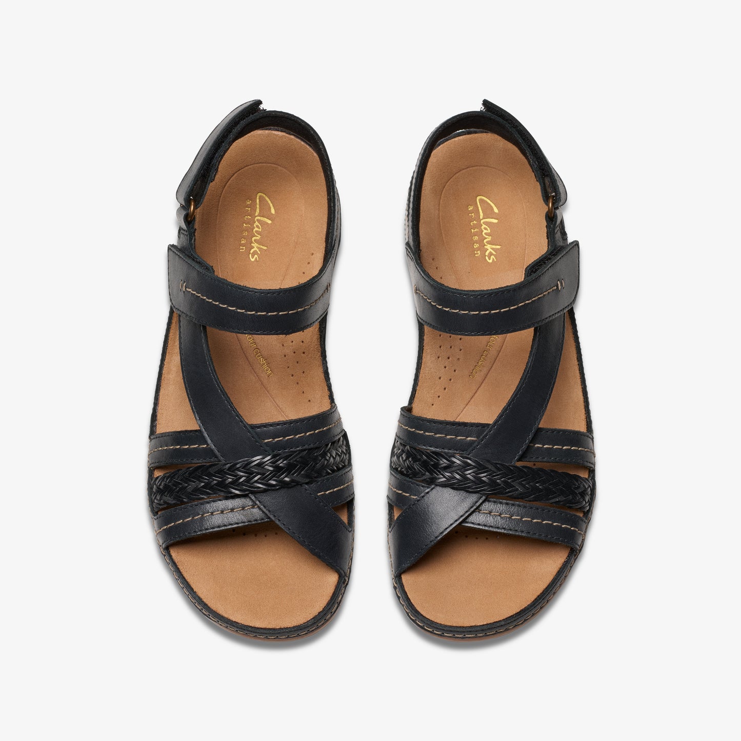Top-down view of black leather sandals with a braided detail across the toes and a Velcro strap at the ankle.