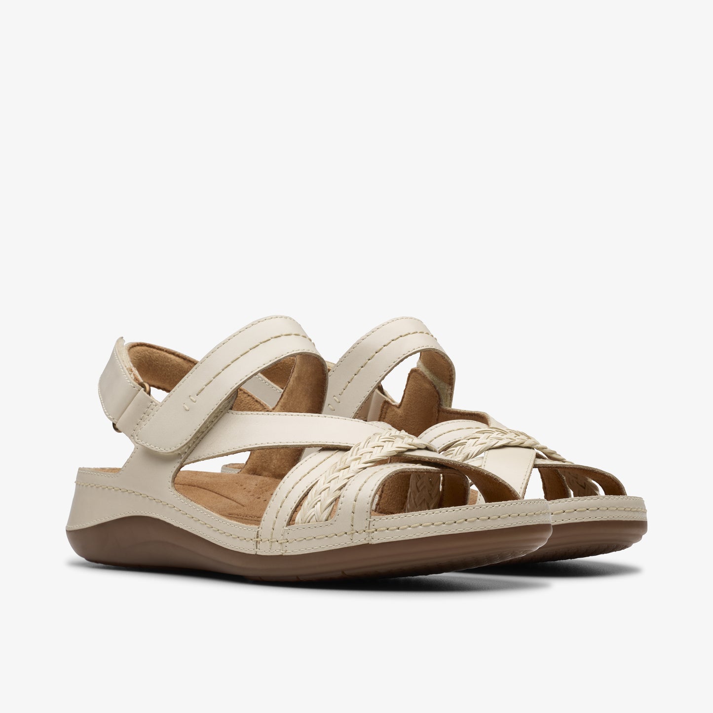 Beige sandals with woven straps and velcro ankle strap.