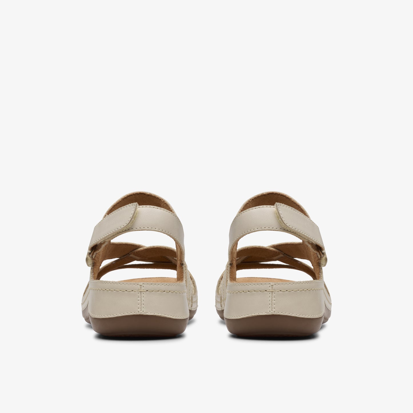 Back view of two women's flat sandals with intertwined straps and velcro ankle closure.