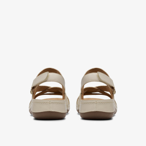Back view of two women's flat sandals with intertwined straps and velcro ankle closure.