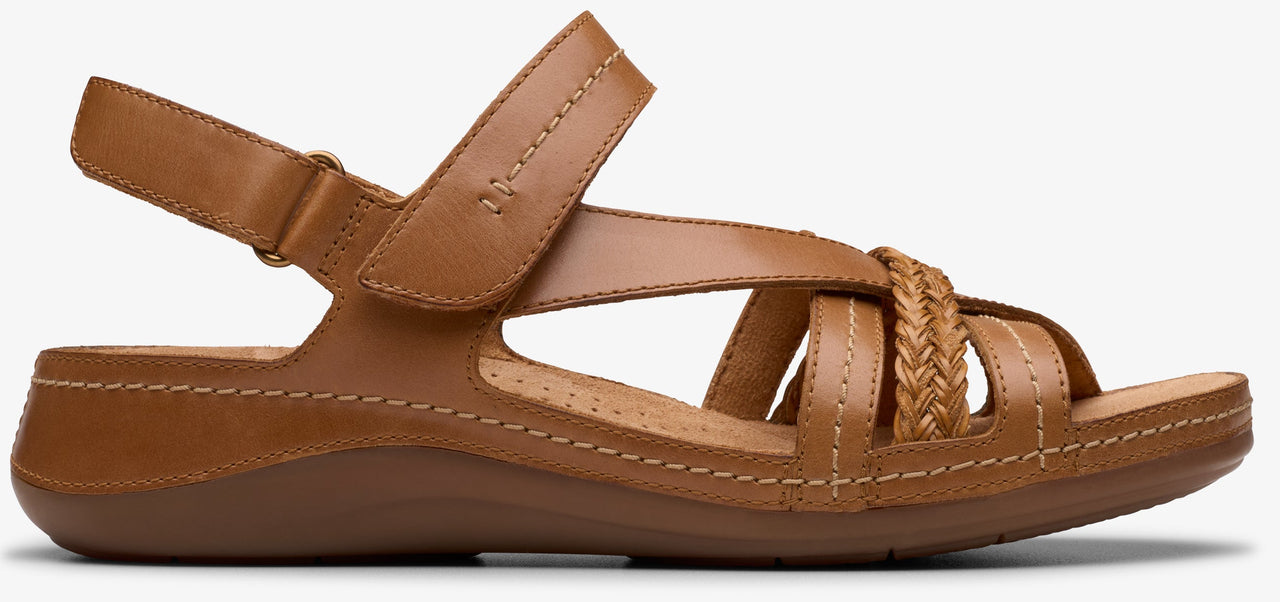 A tan sandal with buckle and interwoven straps.