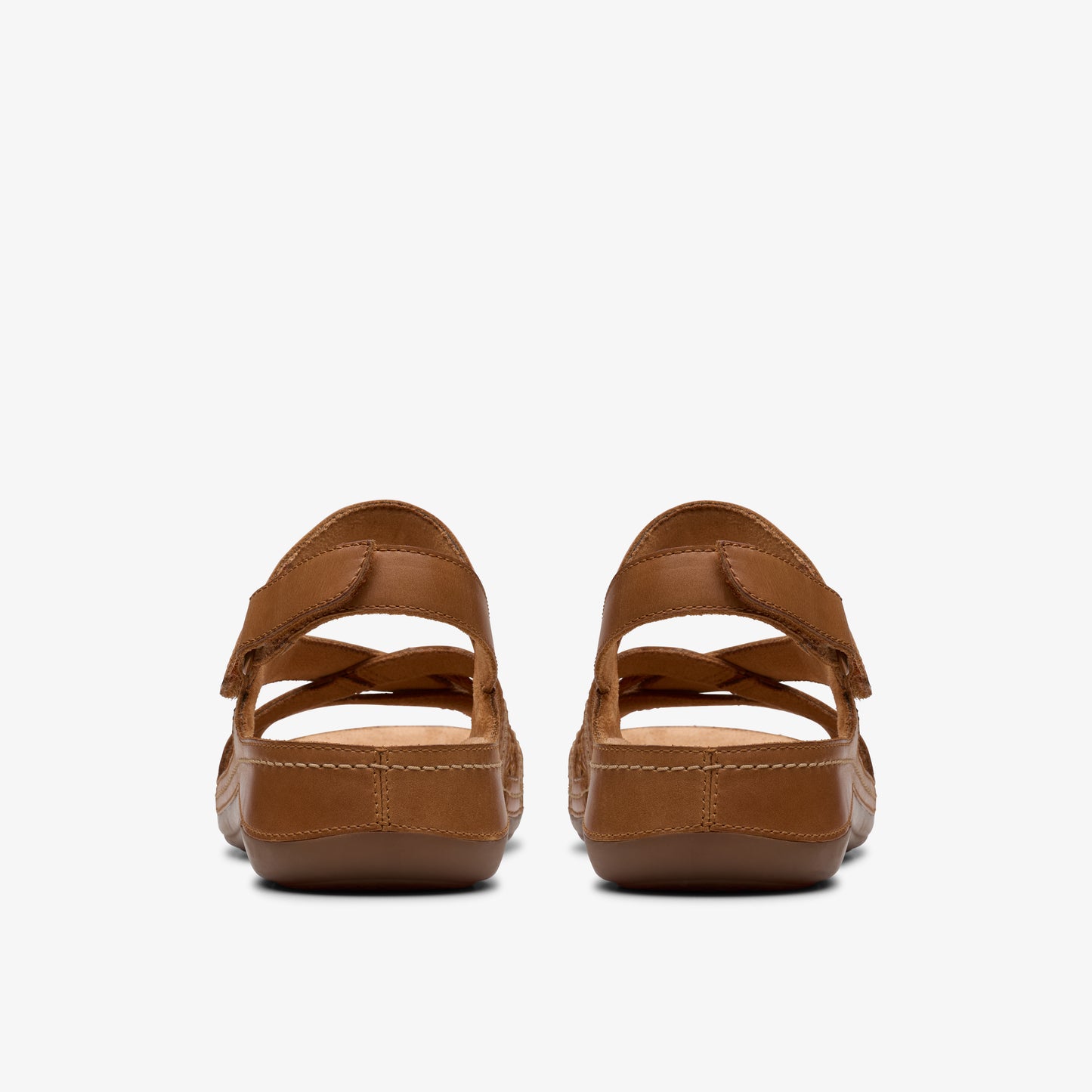Pair of brown sandals with adjustable straps, rear view.