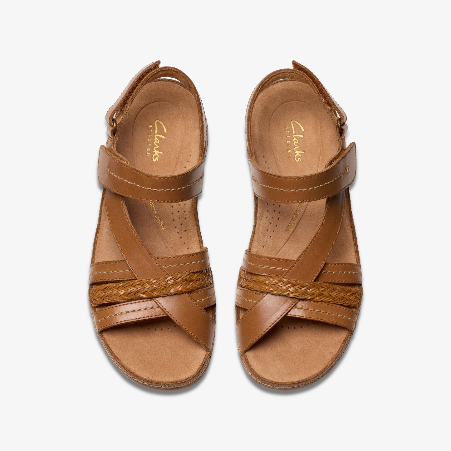 A pair of brown sandals, seen from above, with leather straps and velcro closure.