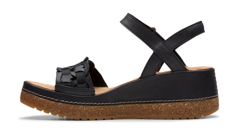 Black platform sandal with woven vamp and ankle strap.