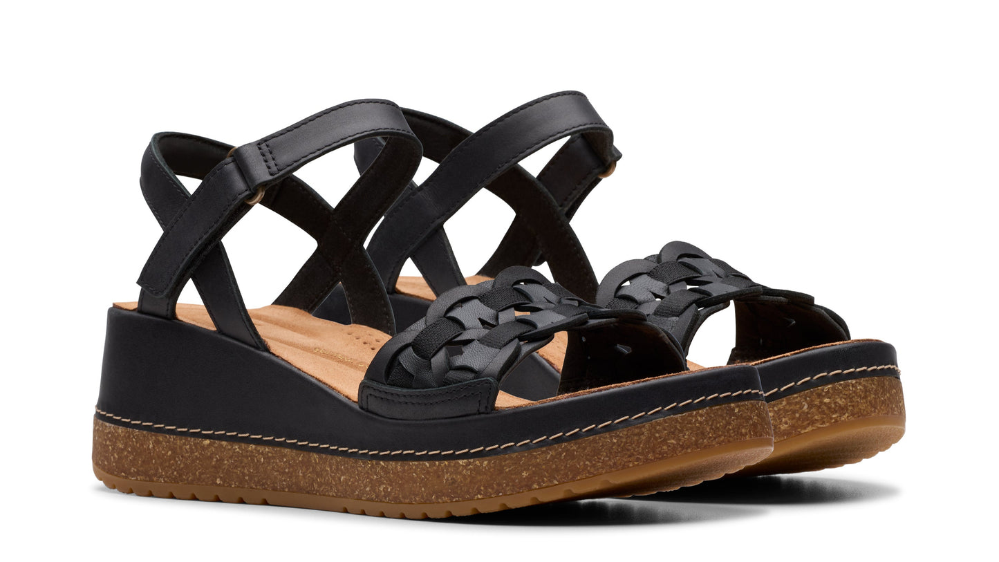 Black wedge sandals with braided straps and adjustable ankle strap.