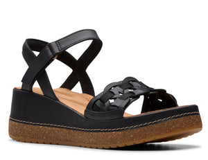 Black wedge sandal with criss-cross ankle strap and woven toe.