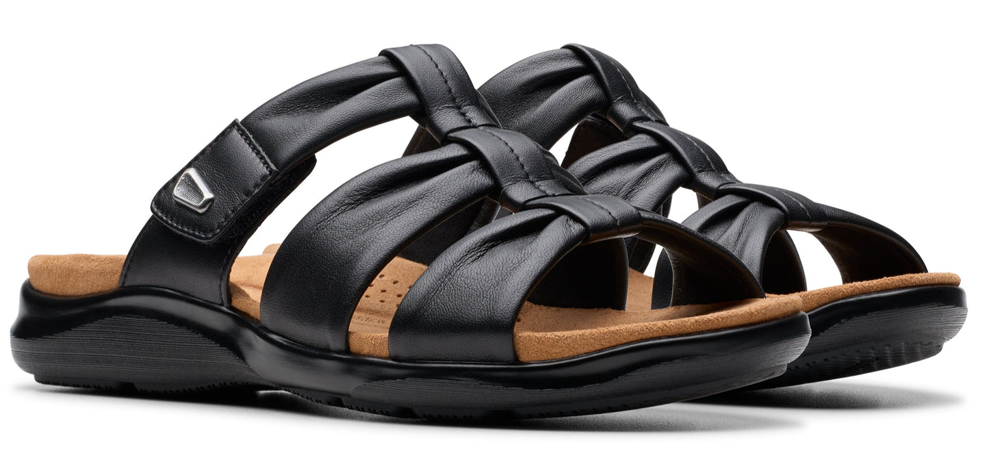 A pair of black leather sandals with straps.