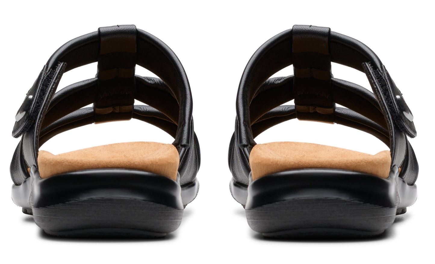 Pair of black sandals with adjustable straps and tan footbeds, back view.