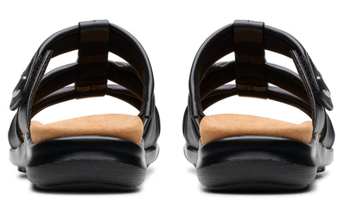 Pair of black sandals with adjustable straps and tan footbeds, back view.