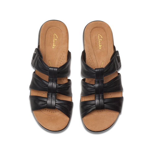 Top-down studio shot of a pair of black leather sandals with three horizontal straps and a buckle.