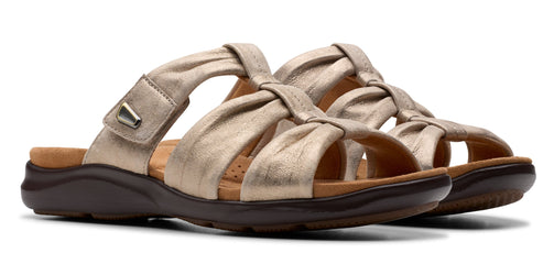 A pair of metallic gold sandals with knotted straps and a slide-on design.
