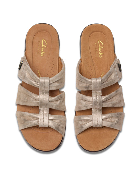 Two open-toed sandals, gold with three straps, adjustable buckle, flat sole.