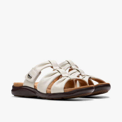 Two white leather slide sandals with brown soles