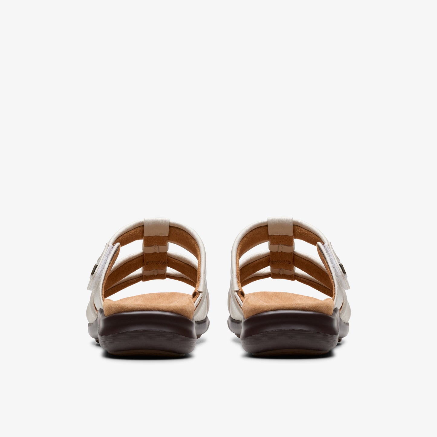 Pair of white strappy sandals with brown soles, viewed from the back.