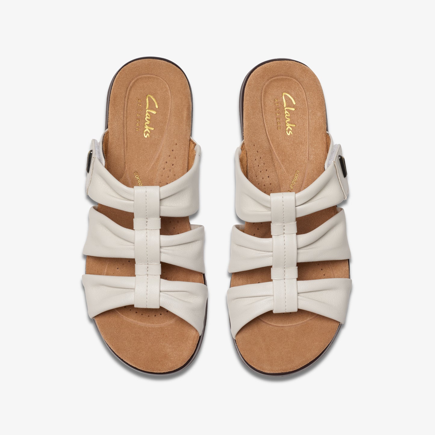 Overhead view of a pair of white leather Clarks sandals with three horizontal straps on top of a brown footbed.