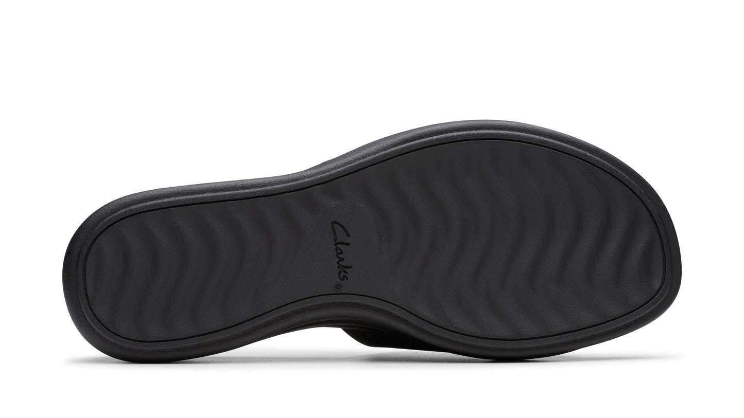Black sandal outsole with a wave-like pattern.