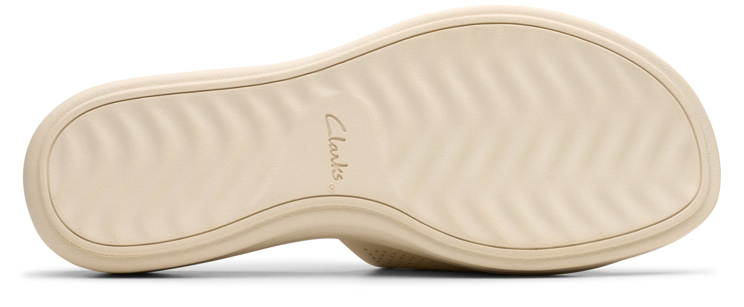 Sole of a light beige shoe with a textured pattern.
