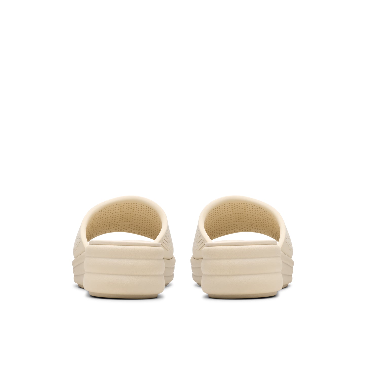 Pair of beige slide sandals, seen from the back.