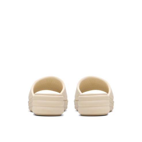 Pair of beige slide sandals, seen from the back.