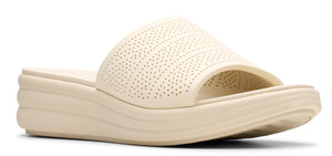 A women's beige slide sandal with a wedge sole and perforated details.