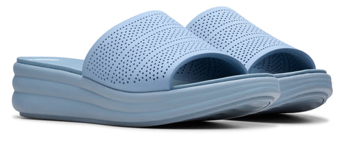 Light blue wedge slide sandals with small holes across the upper.