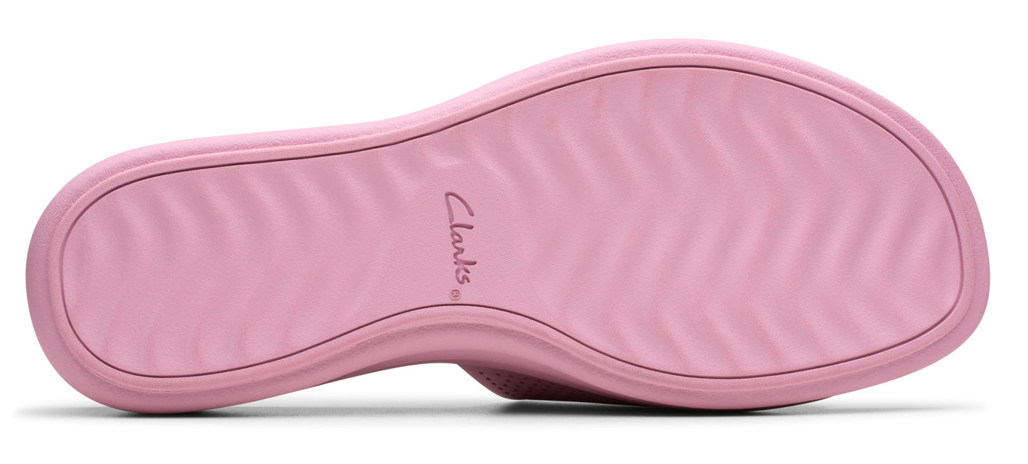 A pink shoe with ridged sole and the word "Clarks".