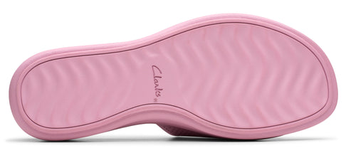 A pink shoe with ridged sole and the word "Clarks".