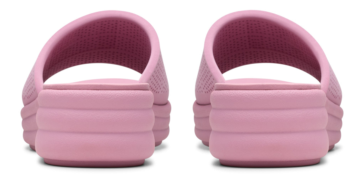 A pair of pink slide sandals with a textured upper and a stacked platform sole, viewed from the rear.