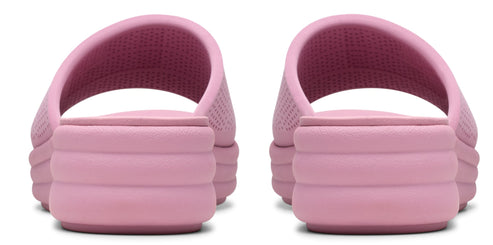A pair of pink slide sandals with a textured upper and a stacked platform sole, viewed from the rear.