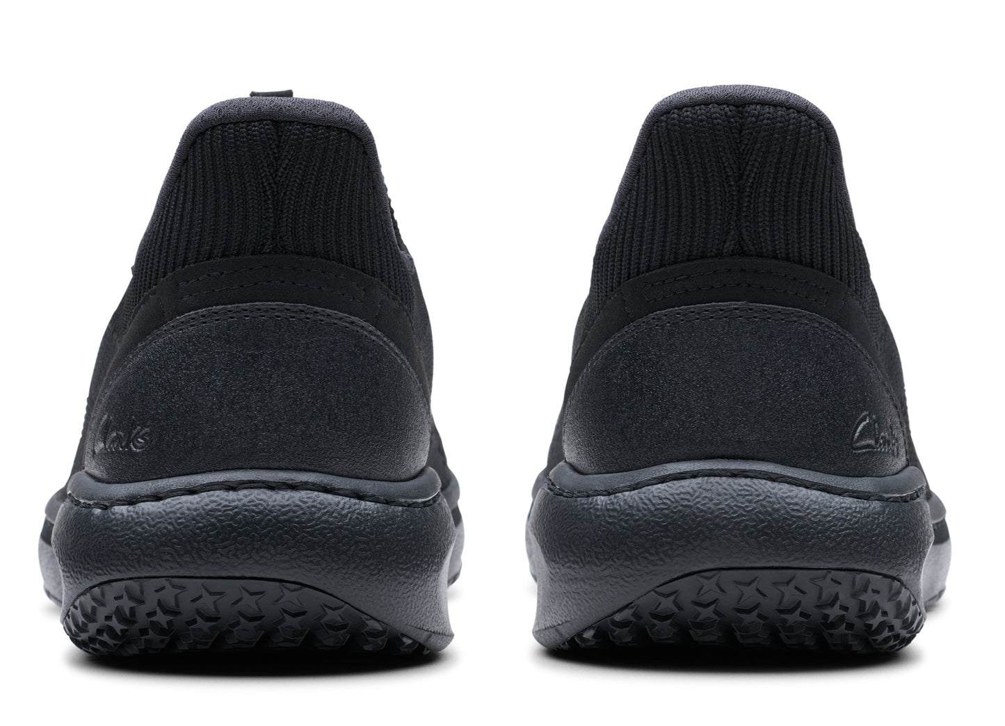 Pair of black shoes, view from the back, with visible soles.