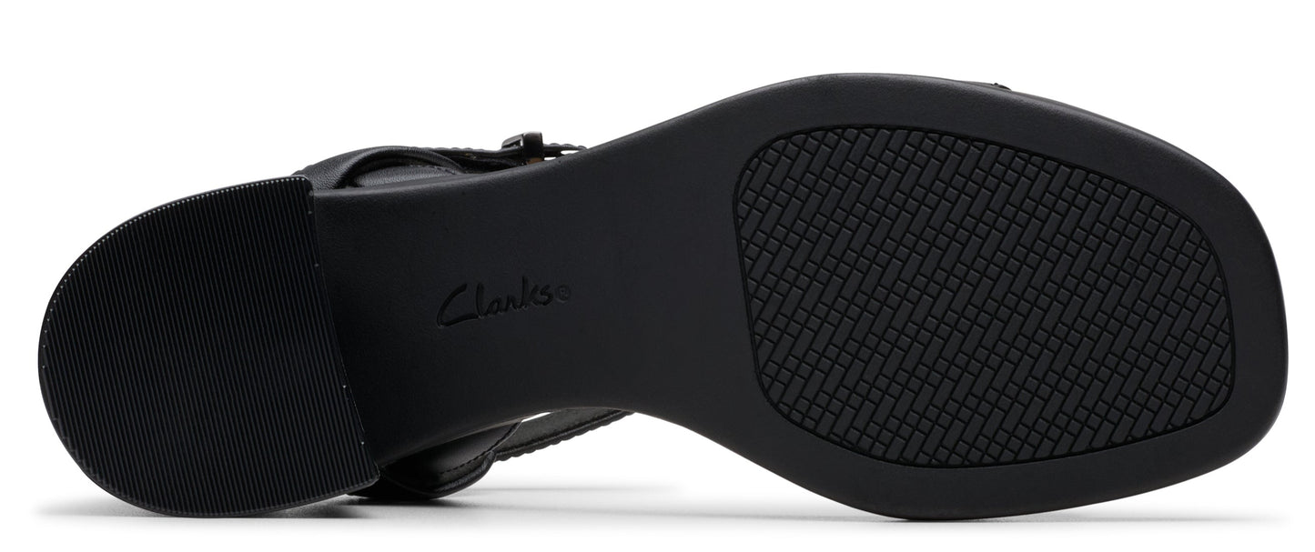A black shoe sole with the brand "Clarks" on it and a textured pattern.