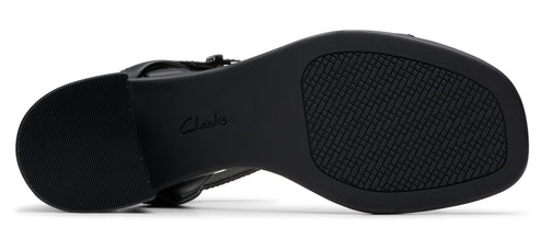 A black shoe sole with the brand "Clarks" on it and a textured pattern.