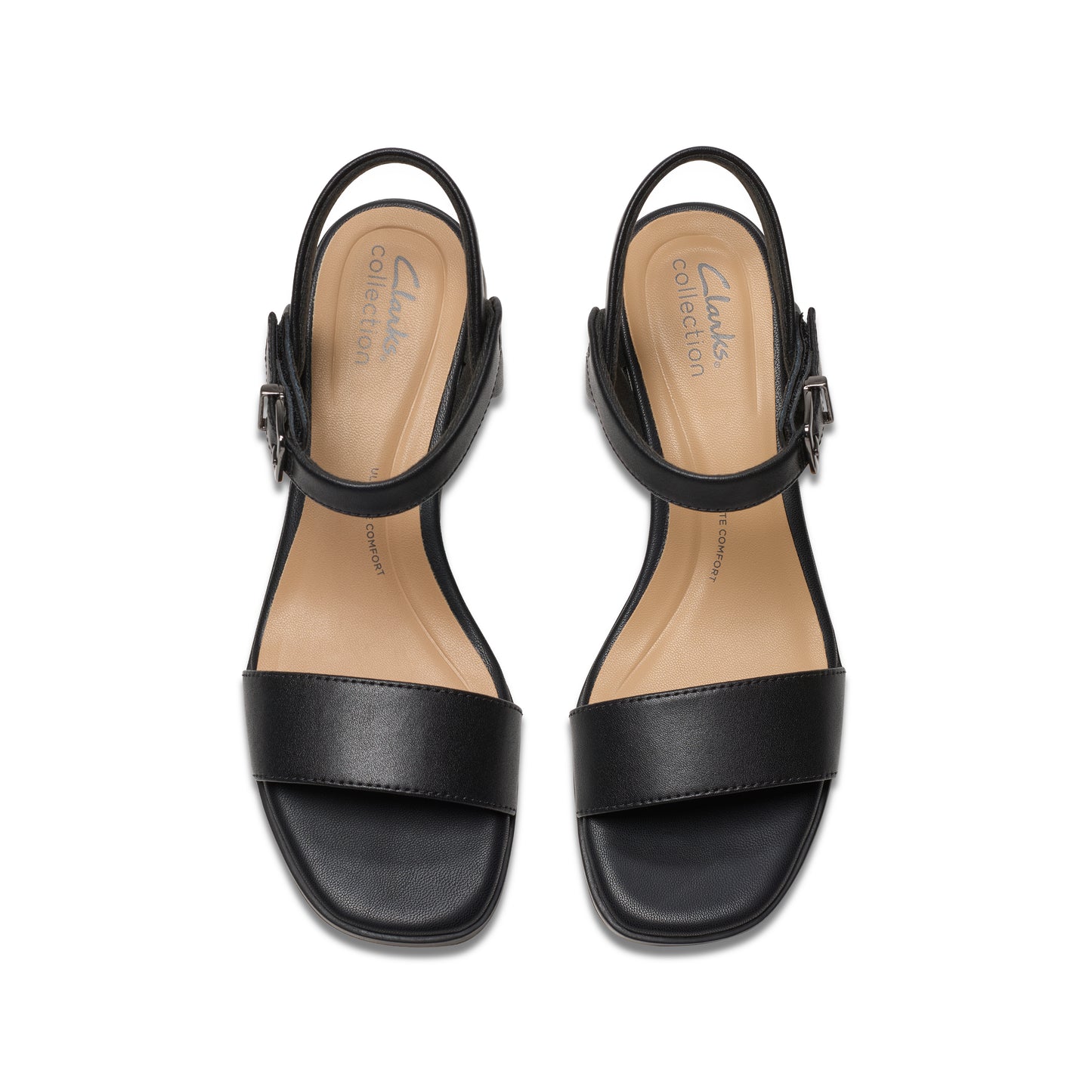Overhead studio shot of a pair of black leather heeled sandals with straps and silver buckles.
