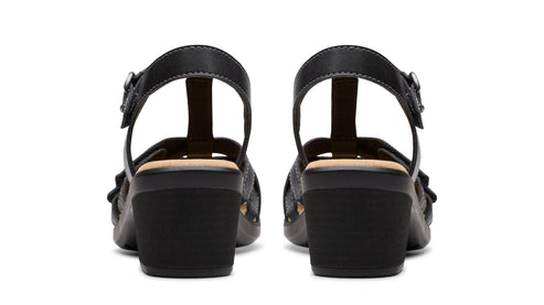 Two black heeled sandals with t-straps and side buckles, viewed from the back.