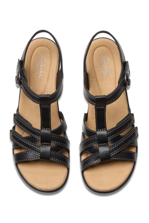 Overhead view of black strappy T-strap sandals with adjustable velcro straps.