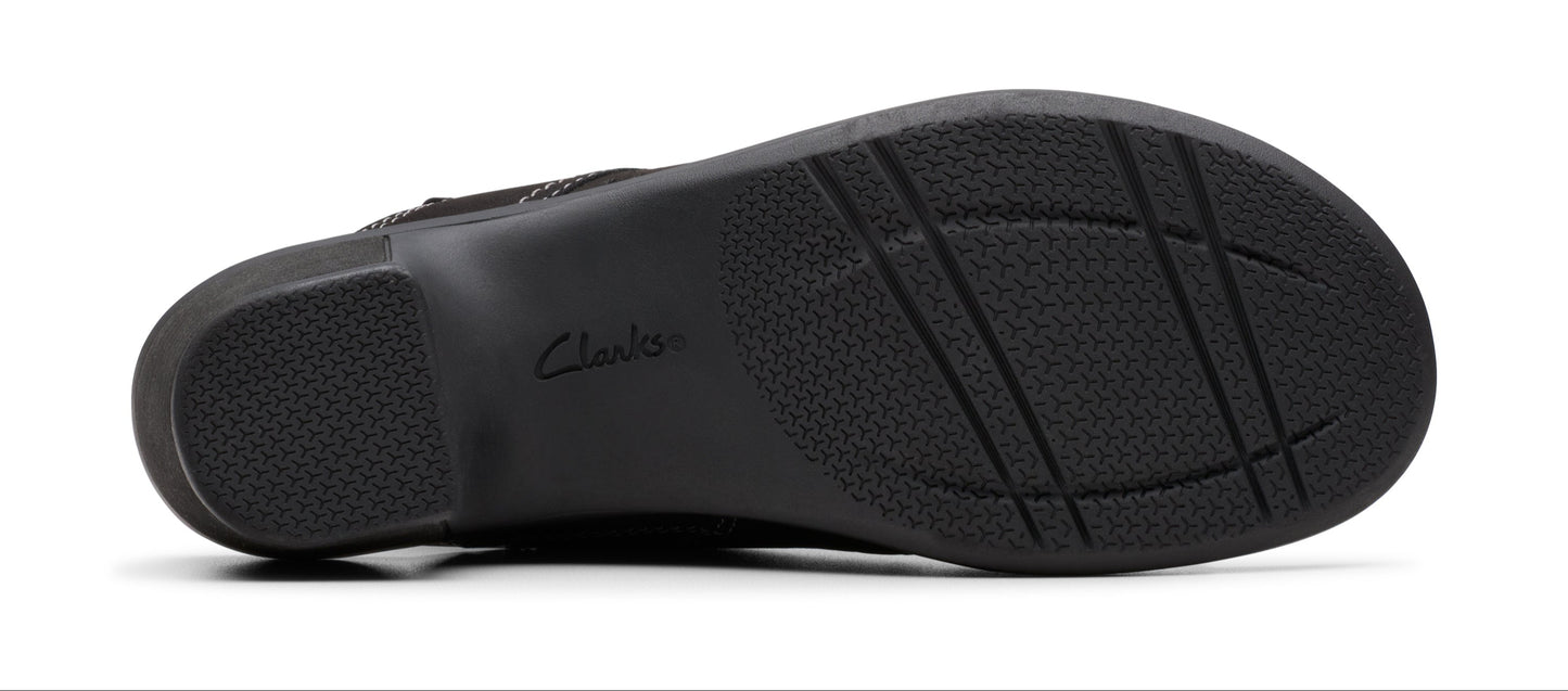 The underside of a black shoe showing the sole.