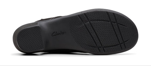 The underside of a black shoe showing the sole.