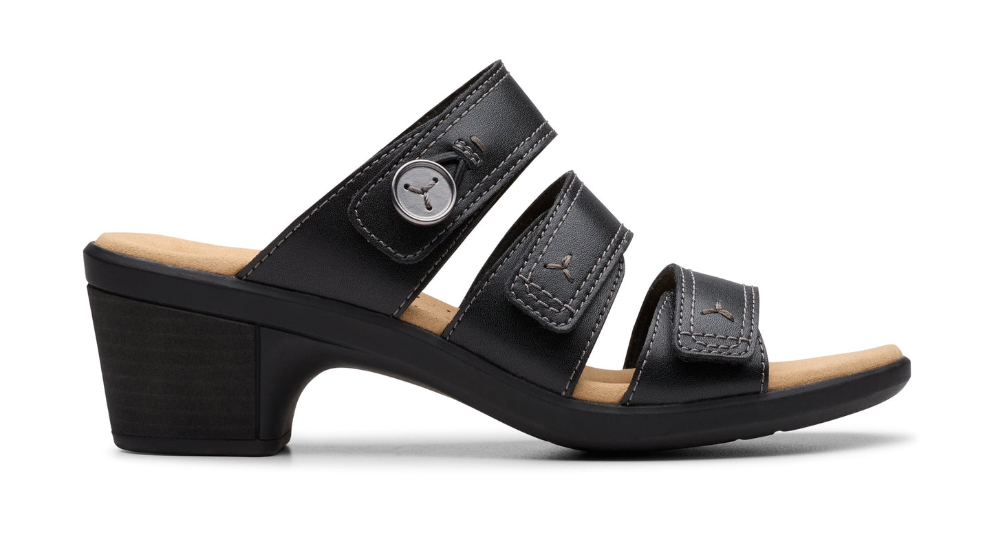 Black, three-strap sandal with low heel and velcro fasteners.