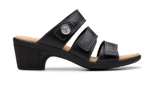 Black, three-strap sandal with low heel and velcro fasteners.