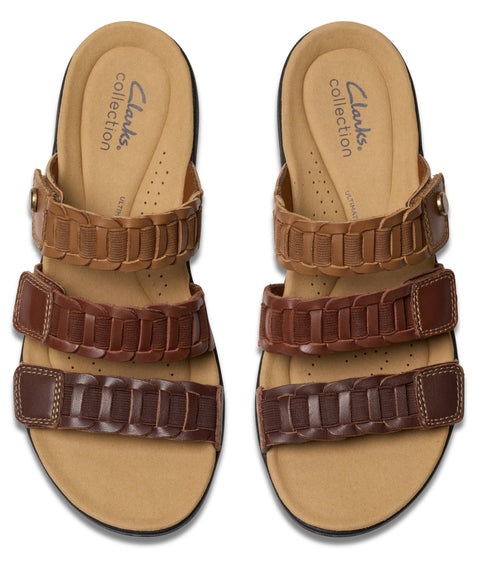 Two slide sandals, each with three braided straps of different brown shades.