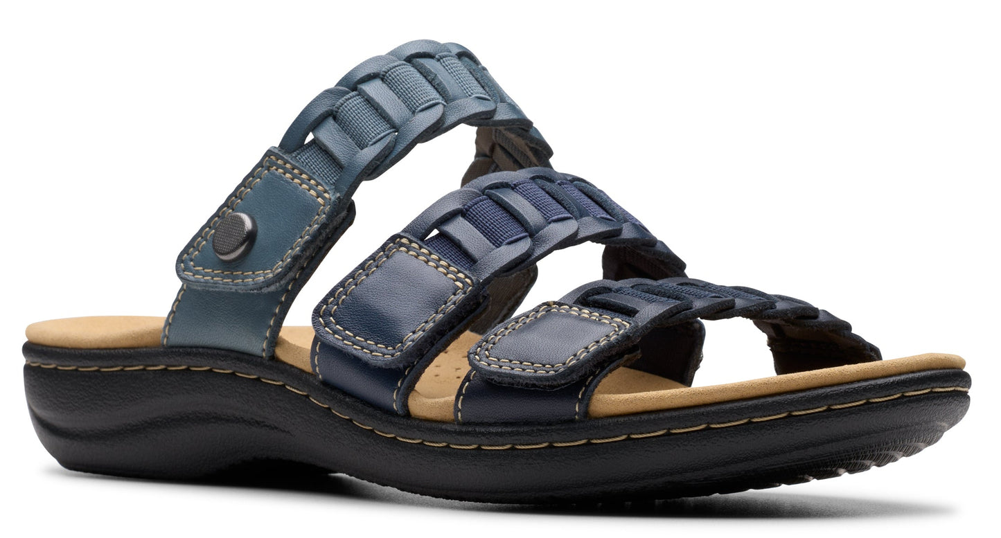 Blue sandal with woven straps and adjustable velcro closures.