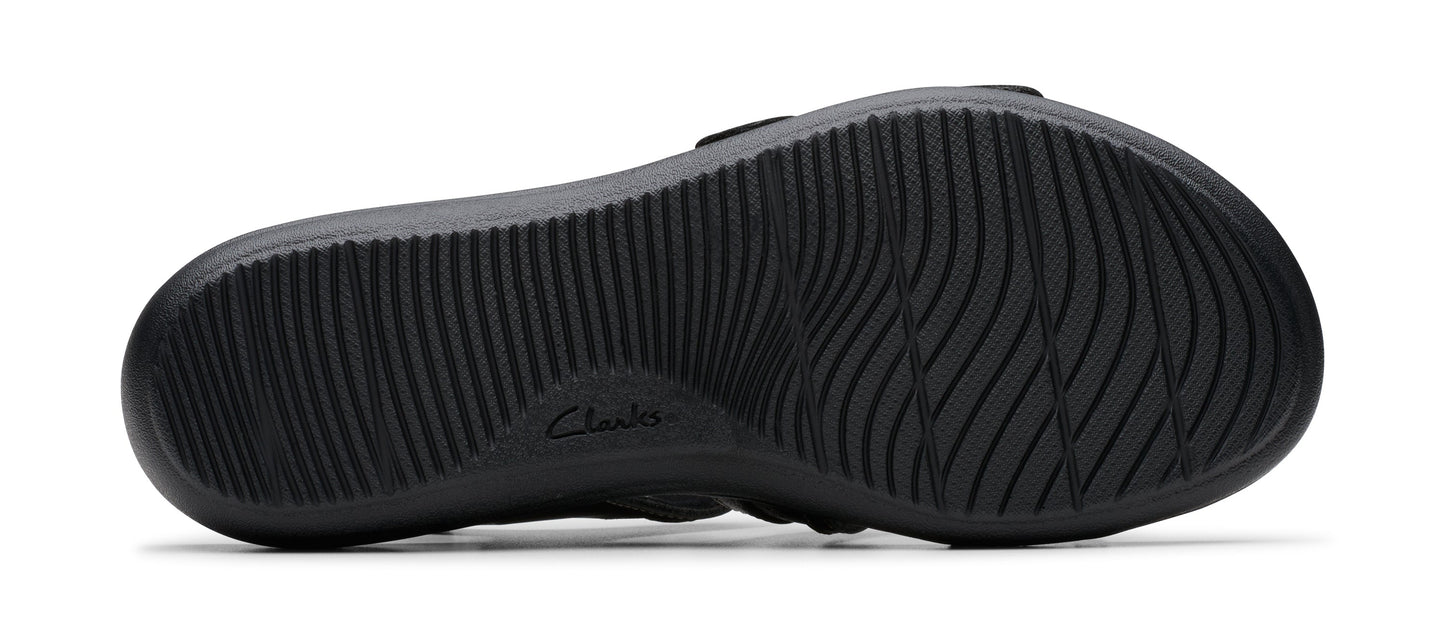 Close-up of a black shoe sole with intricate treads and the text "Clarks" embossed near the center.