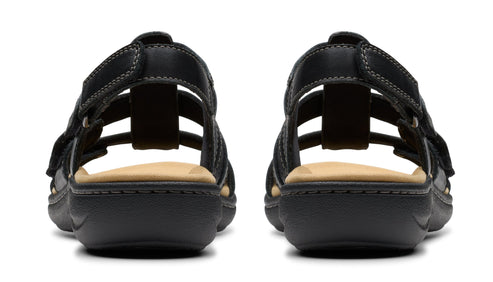 Pair of black leather sandals with multiple straps and velcro closure.