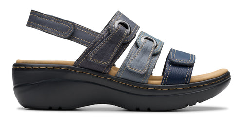 A sandal with three straps in varying shades of blue, with a tan insole and a black platform sole.