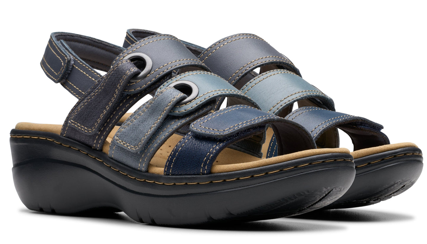 Pair of platform sandals with blue, gray, and light blue straps and velcro closures.