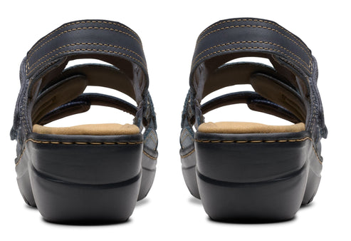 Back view of two blue leather sandal clogs with stacked heels.