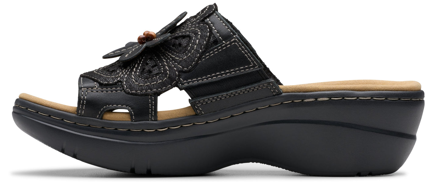 Black sandal with a flower on the front.