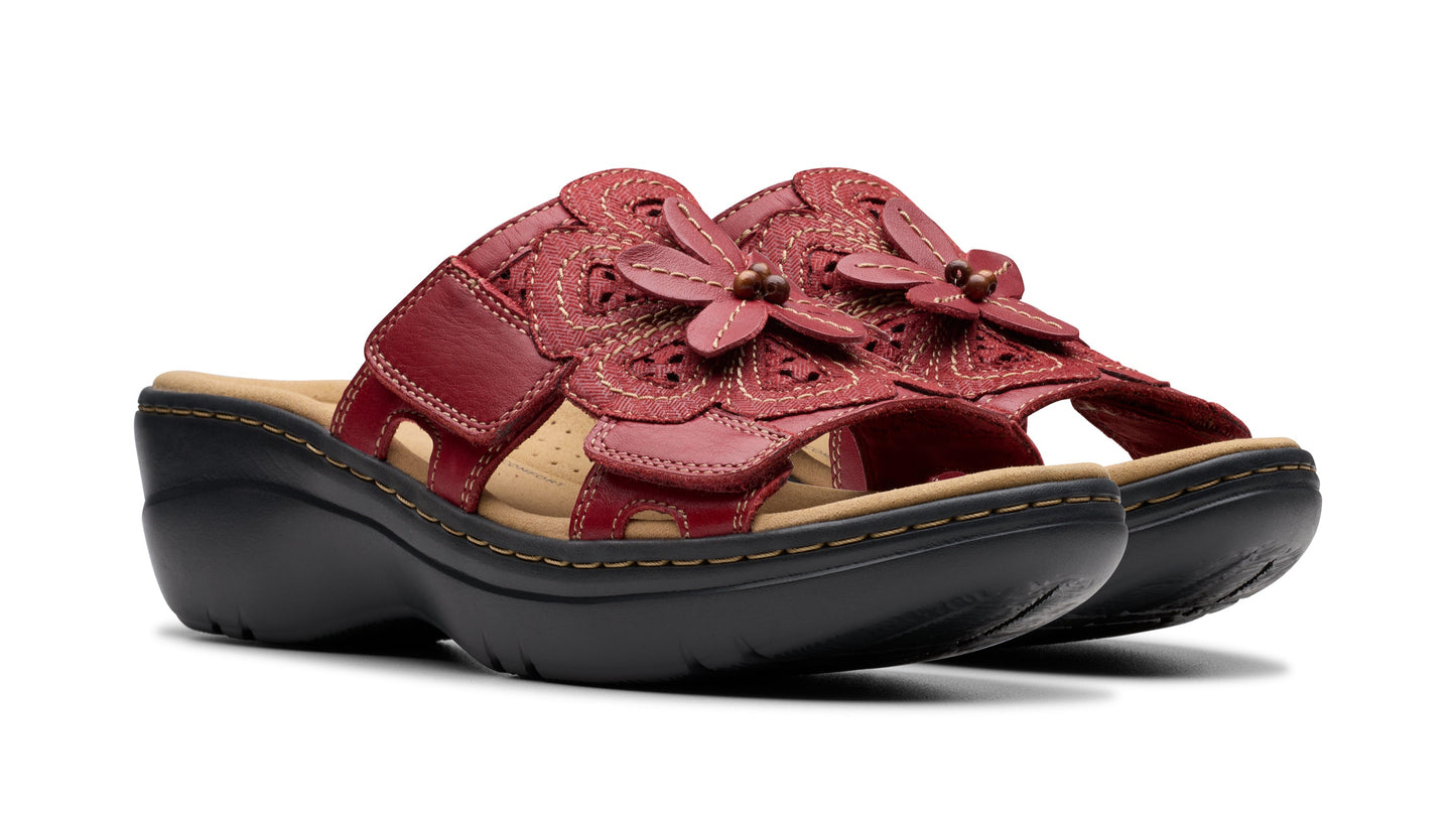 Pair of red leather flower adorned slide sandals with black soles