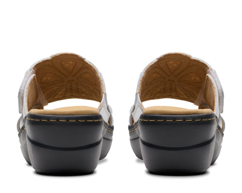 Back view of two floral patterned white sandals with a dark gray sole.