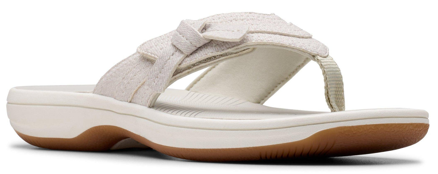 A beige flip-flop sandal with a bow.